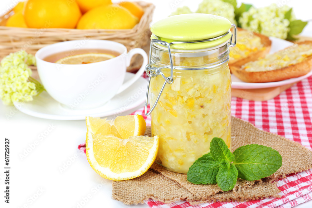 Tasty lemon jam with cup of tea on table close-up Tasty lemon jam with cup of tea on table close-up