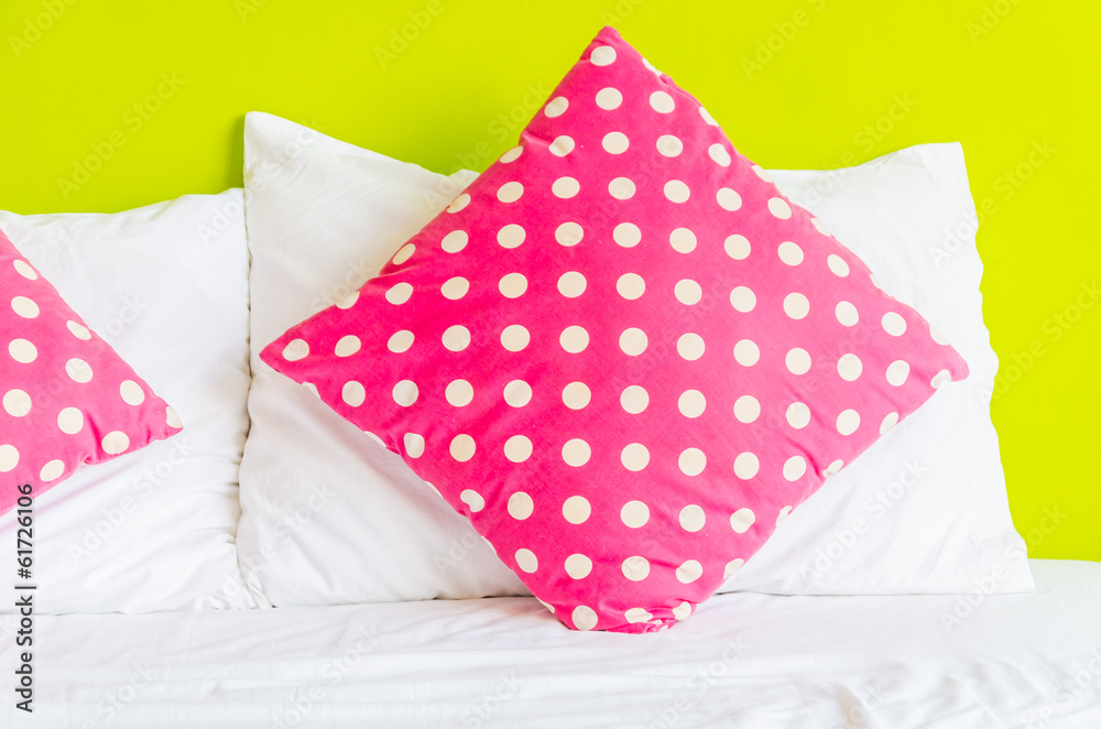 Colorful polka pillow on white bed Colorful polka pillow on white bed