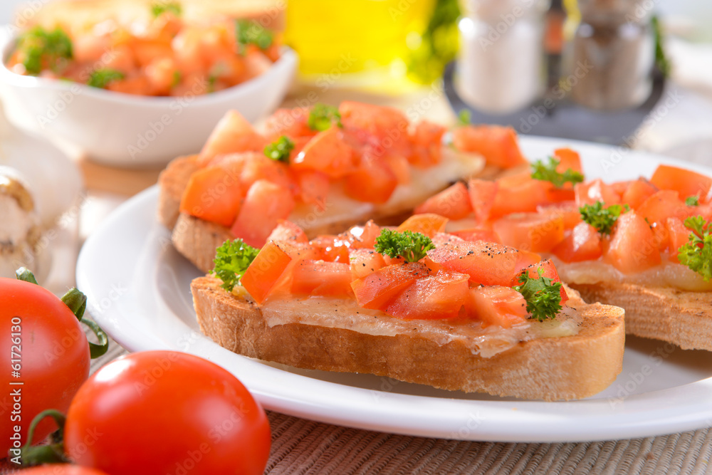 Delicious bruschetta with tomatoes on plate on table close-up Delicious bruschetta with tomatoes on plate on table close-up