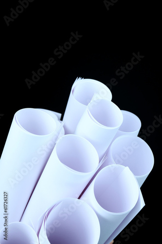 White paper rolls on black background close-up