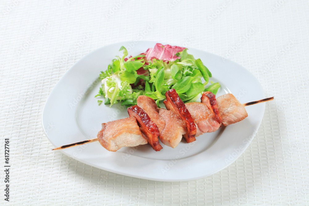 Pork skewer with salad greens Pork skewer with salad greens