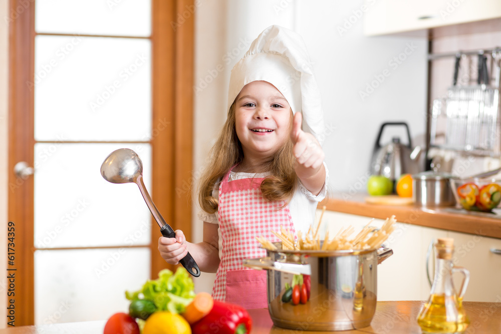 Chef girl preparing healthy food and showing thumb up Chef girl preparing healthy food and showing thumb up