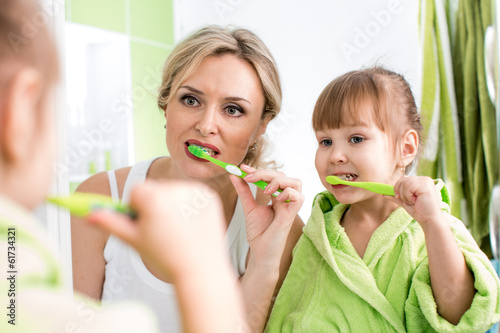 mother with child brushing teeth #61734321