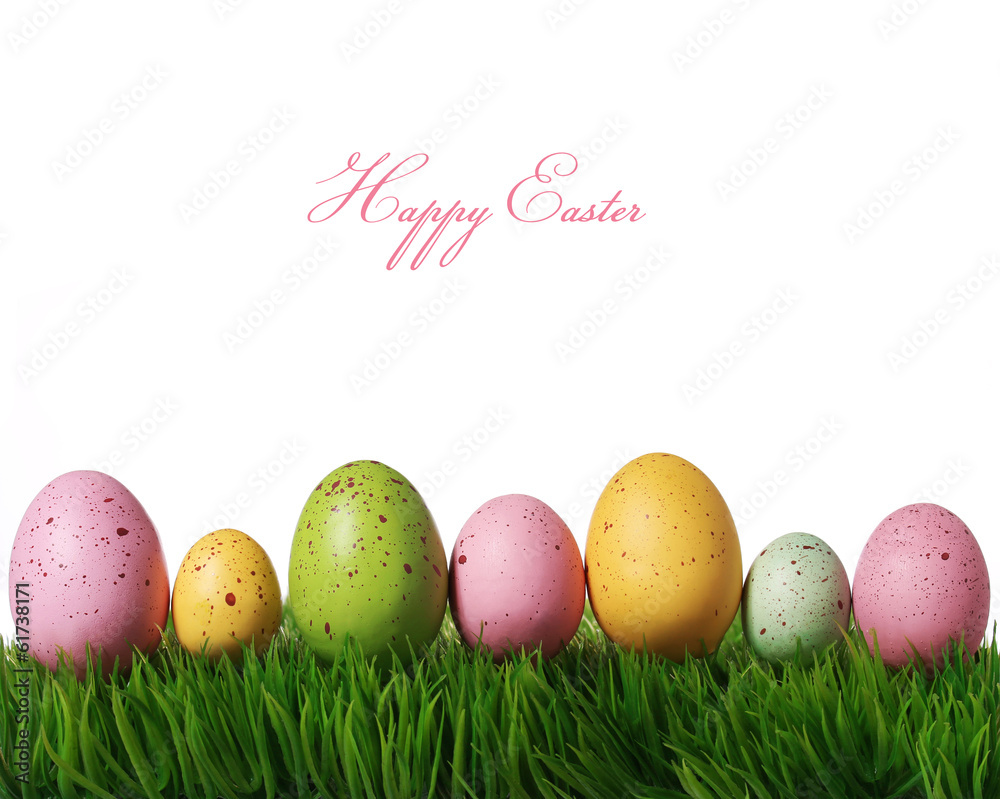 Colorful easter eggs on green grass isolated on white with copy