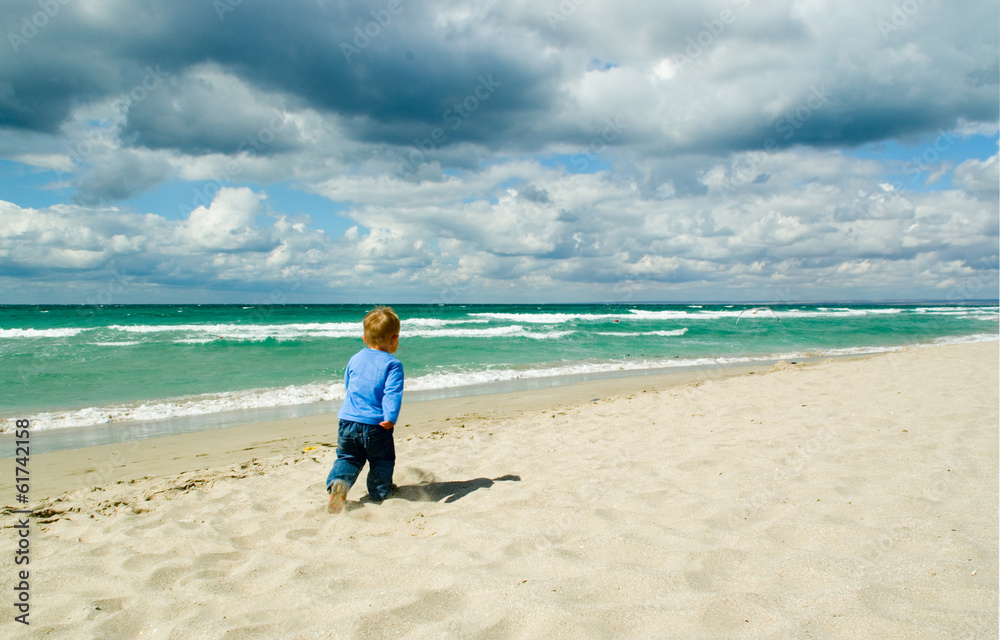 Little boy running on a beach