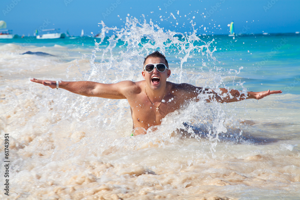 man in water waves of tropical sea