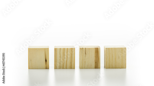 Four wooden cubes or building blocks