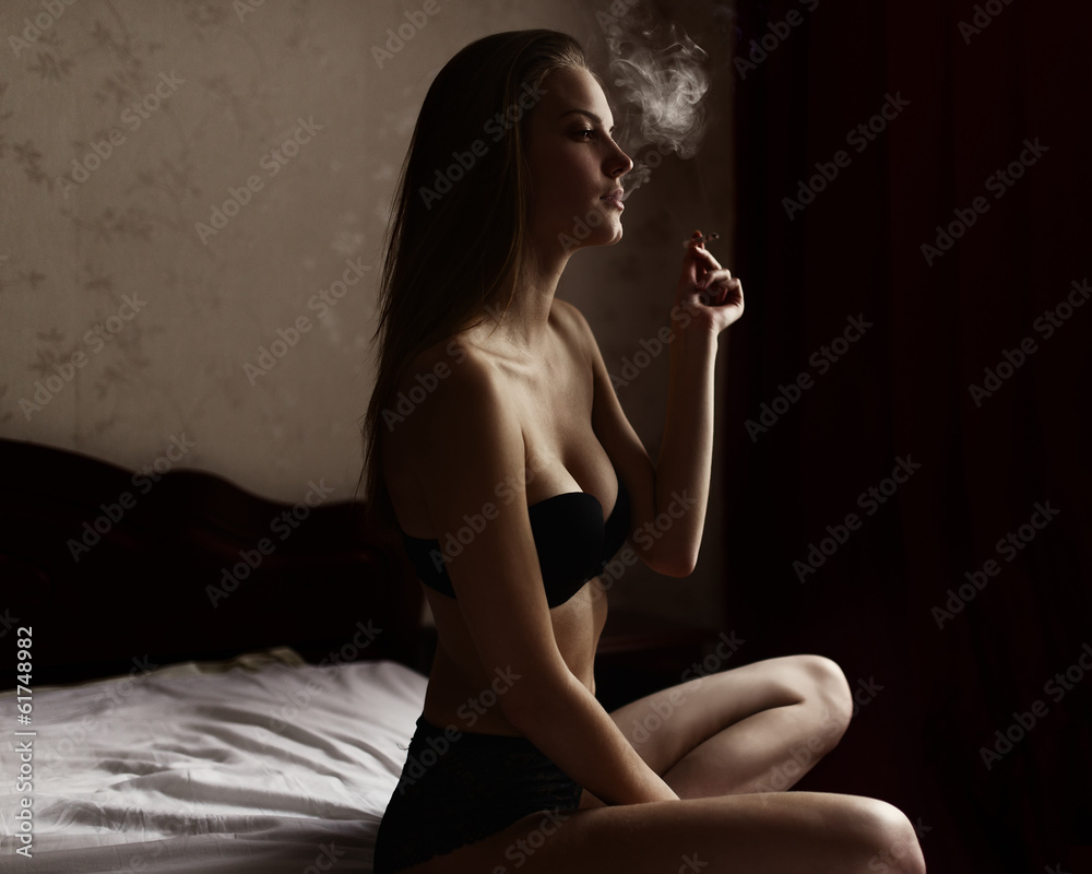 Beautiful sexy in lingerie smoking in bed foto de Stock | Adobe Stock