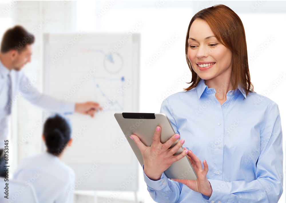 smiling woman looking at tablet pc at office smiling woman looking at tablet pc at office