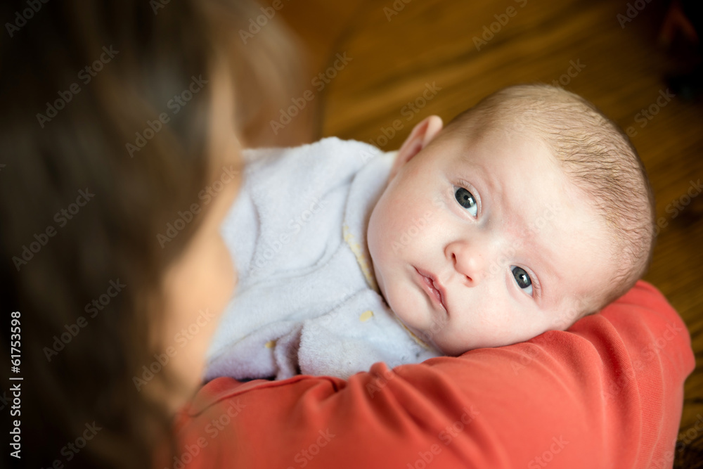 Baby held in mother's arms for comfort Baby held in mother's arms for comfort