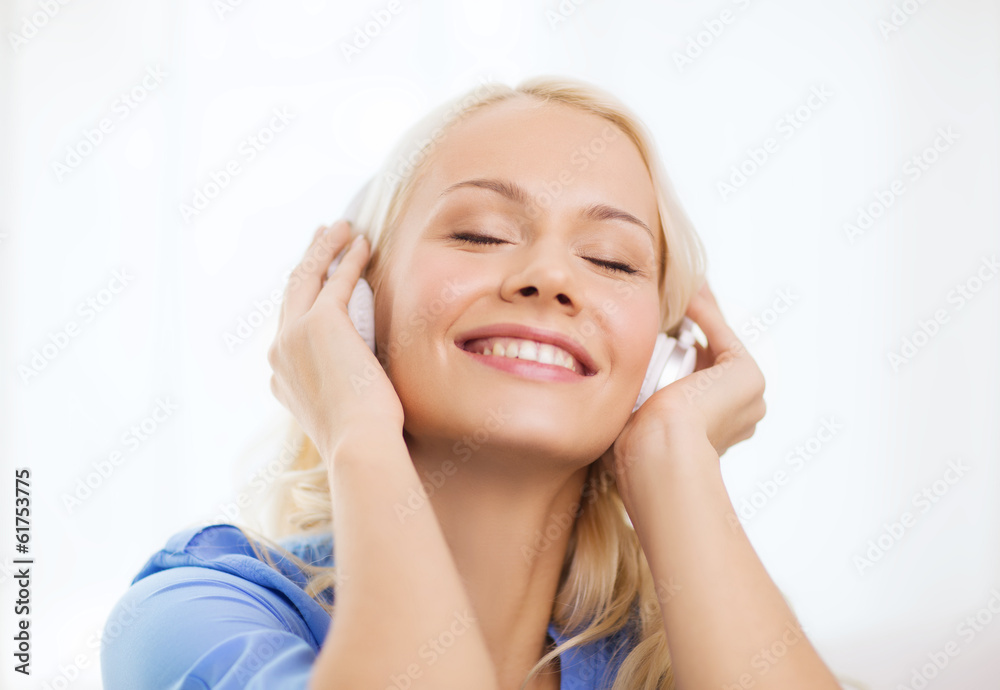 smiling young girl in headphones at home