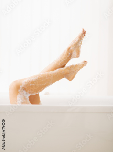 Closeup on young woman in bathtub showing legs