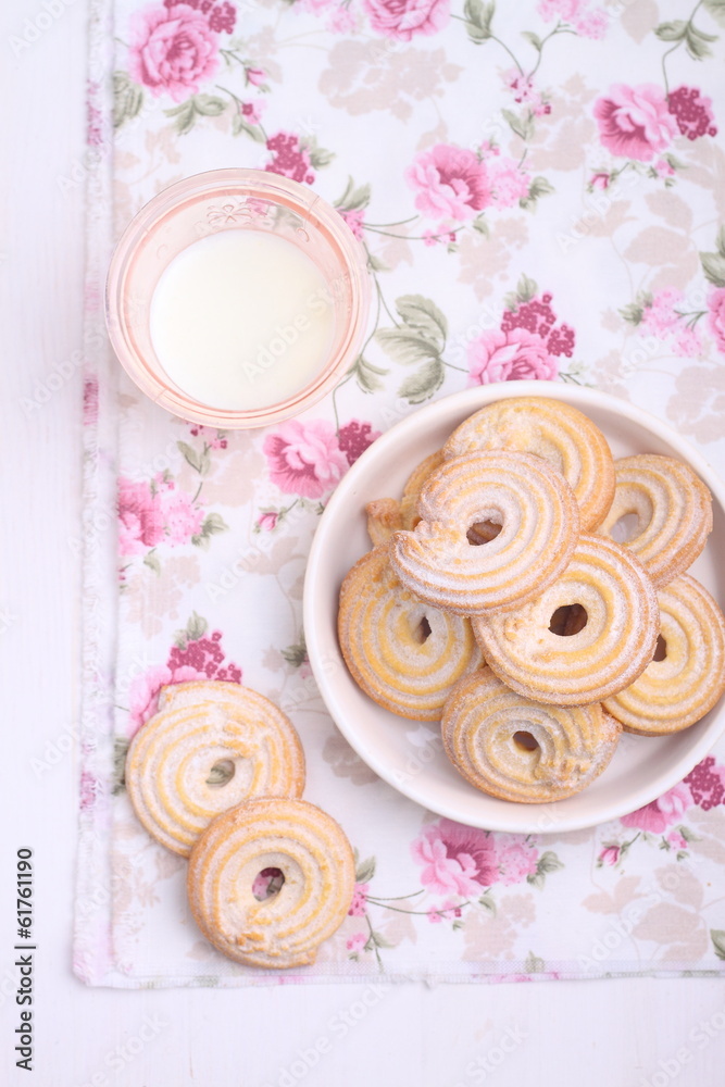sweet cookies with powdered sugar and a glass of milk sweet cookies with powdered sugar and a glass of milk