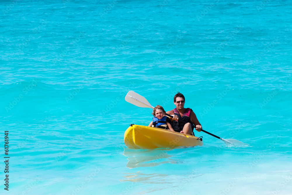 Father and son on a kayak ride in a tropical ocean