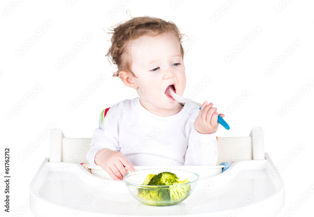 Funny baby having lunch in a white chair Funny baby having lunch in a white chair