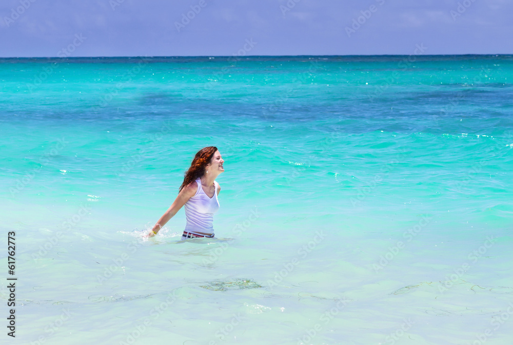 Young beautiful woman swimming in the ocean Young beautiful woman swimming in the ocean