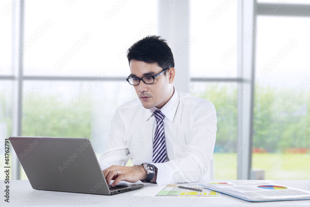 Young businessman is working at office Young businessman is working at office
