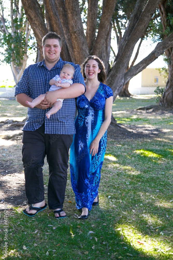Young parents with their baby at the park.