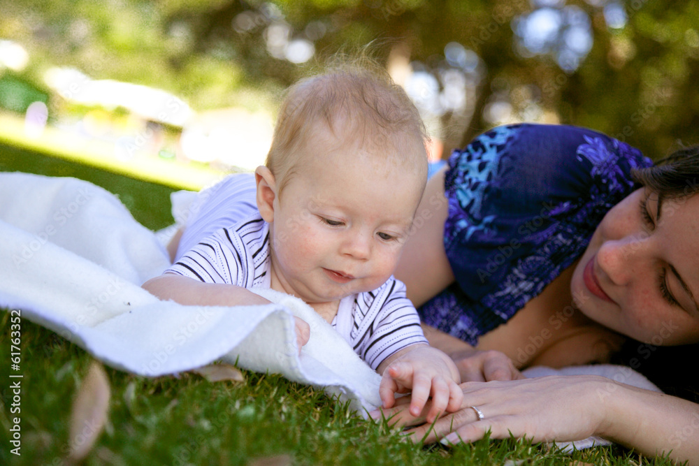 Young parents with their baby at the park.