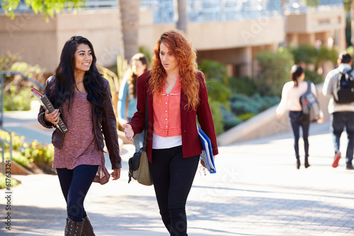 Female Students Walking Outdoors On University Campus