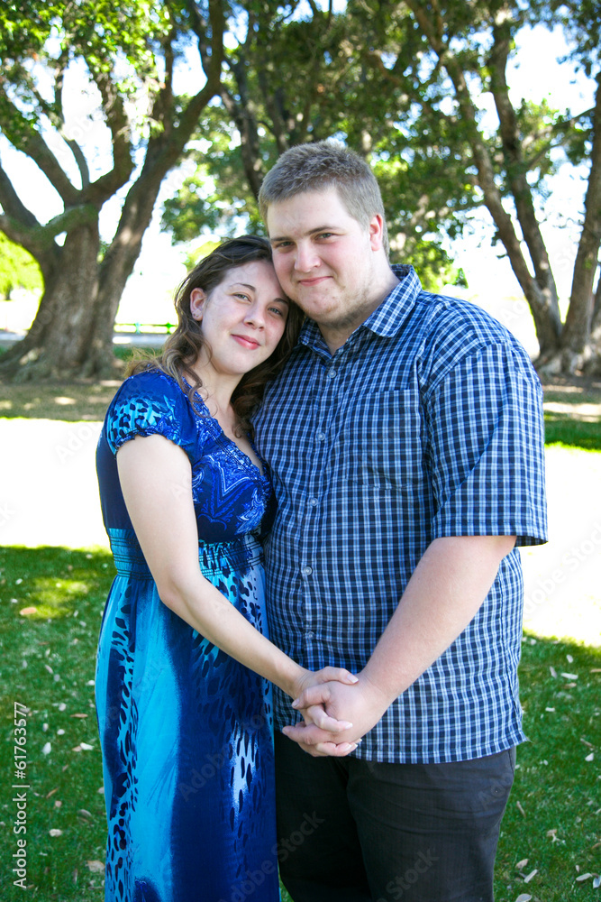 Young parents with their baby at the park.