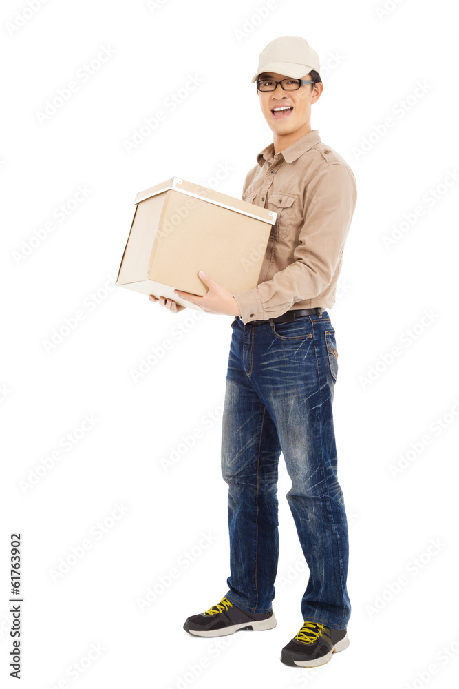smiling  delivery man holding parcel and standing