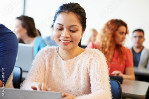 Female University Student Using Digital Tablet In Classroom