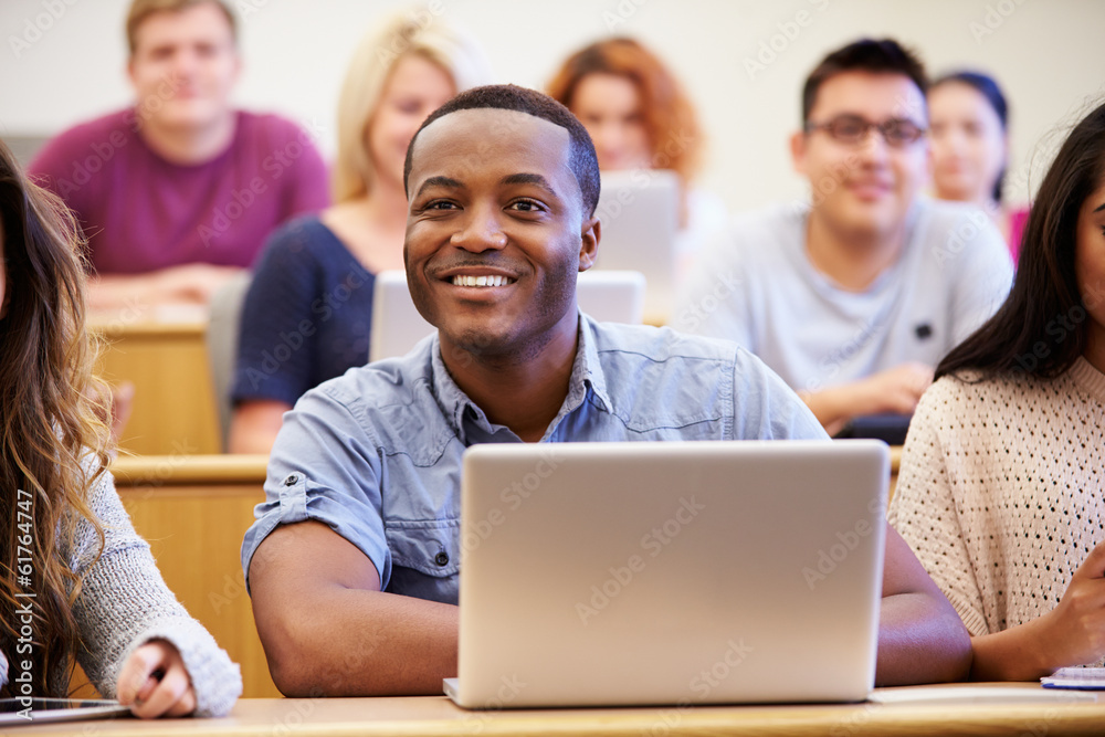Male University Student Using Laptop In Lecture Male University Student Using Laptop In Lecture