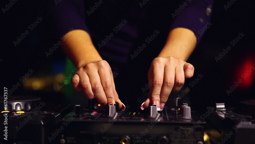 Hands of woman dj working with sound mixer Hands of woman dj working with sound mixer