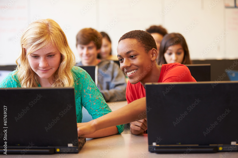 © Monkey Business - Group Of High School Students In Class Using Laptops