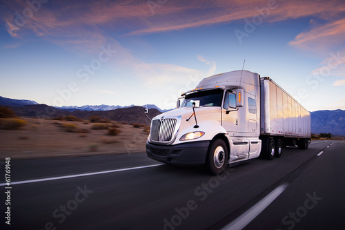 Truck and highway at sunset - transportation background Fototapeta