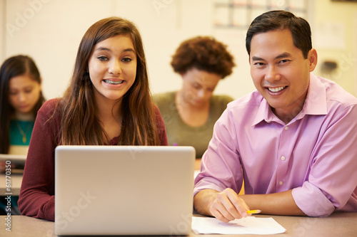 High School Student With Teacher In Class Using Laptop © Monkey Business