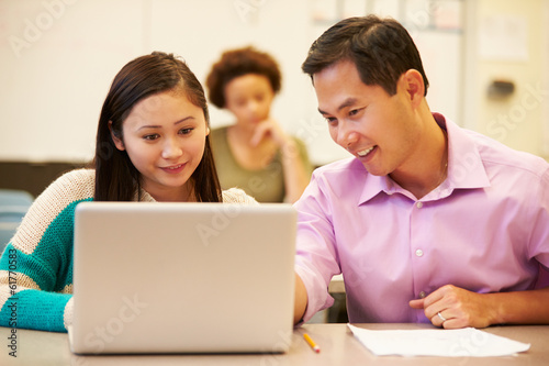 High School Student With Teacher In Class Using Laptop