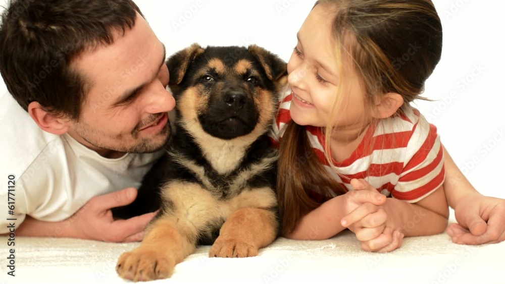 father with his daughter and a German Shepherd puppy father with his daughter and a German Shepherd puppy