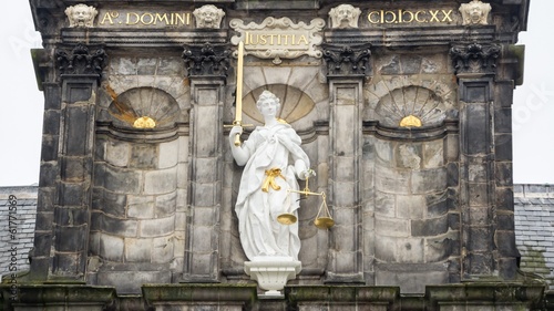 Fotografie Lady justice statue at the City hall of Delft in the Netherlands