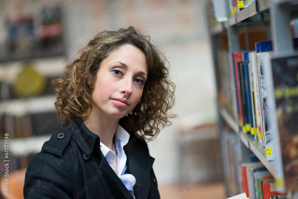 beautiful young woman reading books in public library beautiful young woman reading books in public library