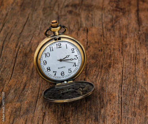 Vintage pocket watch on wooden background