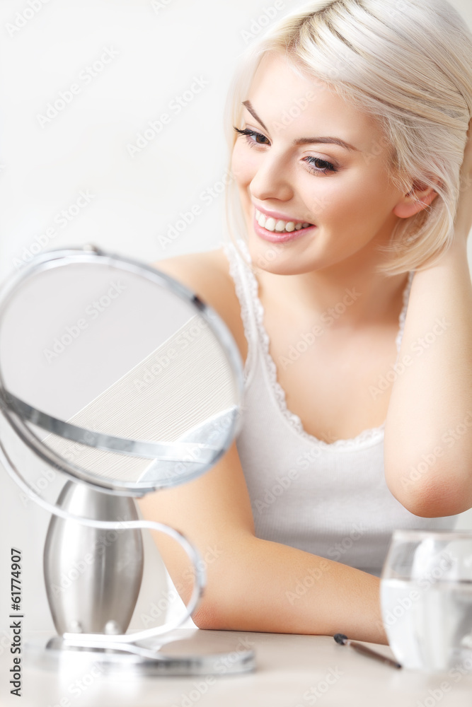Makeup Applying.  Woman Looking at Her Face in the Miror