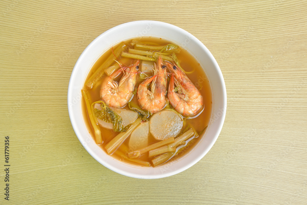 sour soup made of tamarind paste (Thai food) on a wooden table sour soup made of tamarind paste (Thai food) on a wooden table