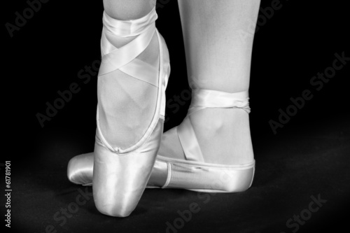 A ballet dancer standing on toes while dancing artistic conversi photo