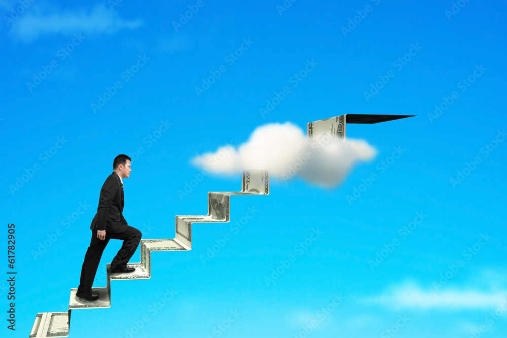 businessman on money stairs to top
