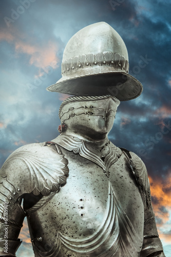 Antivirus.Medieval armor over clouds background. Concept of fire
