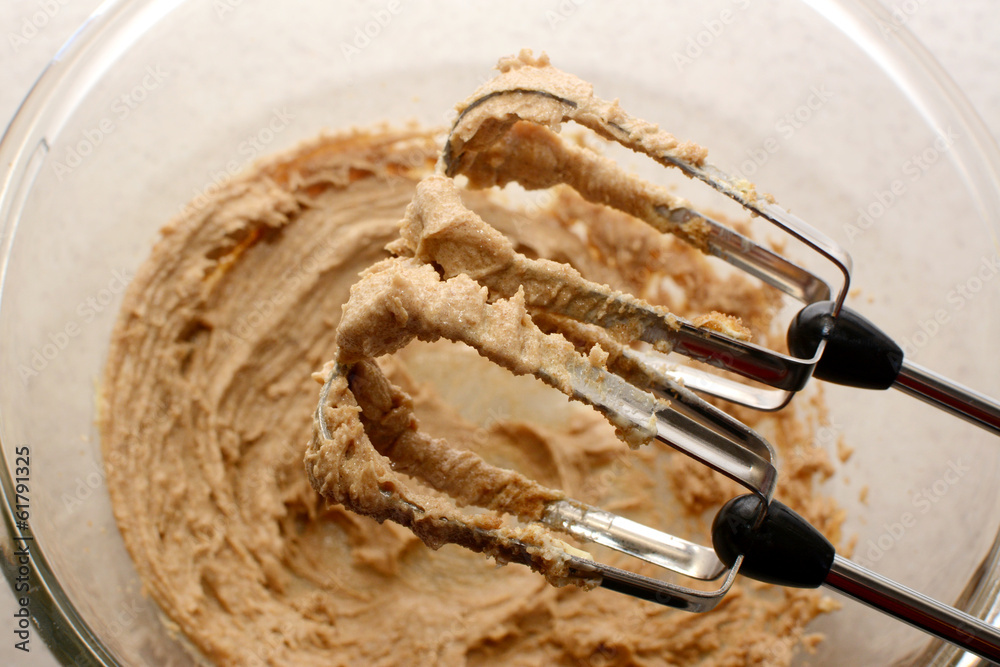 Fototapeta premium Creaming sugar and butter together with a hand mixer