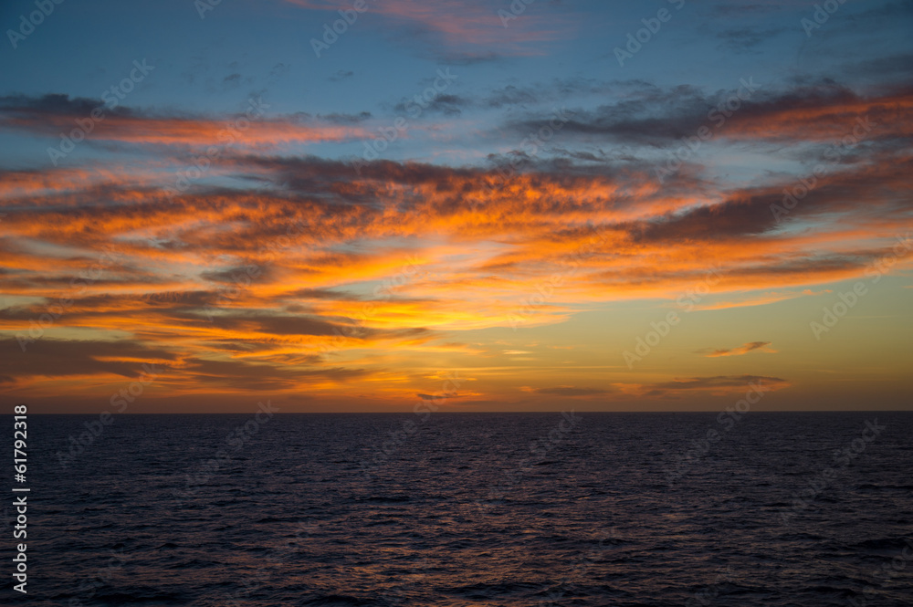 Seascape at sunset with colorful cloudscape