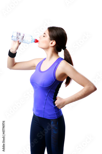 Young sport woman drinking water isolated on white background © Drobot Dean