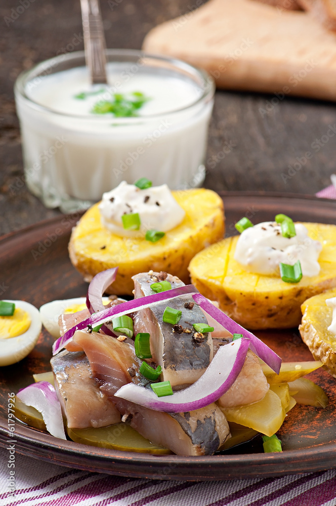 Herring salad with onions and baked potato Herring salad with onions and baked potato