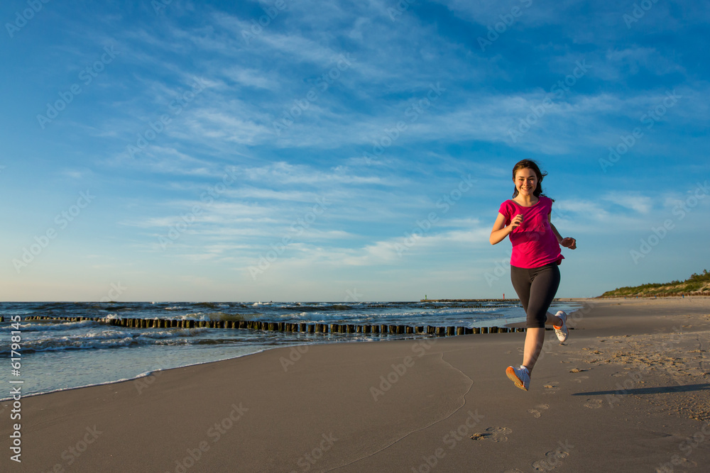 Teenage girl running, jumping on beach Teenage girl running, jumping on beach