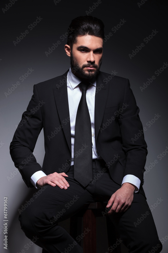 young fashion business man sits on chair