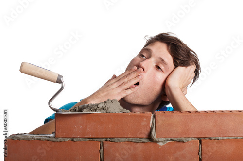 Bored bricklayer yawning photo