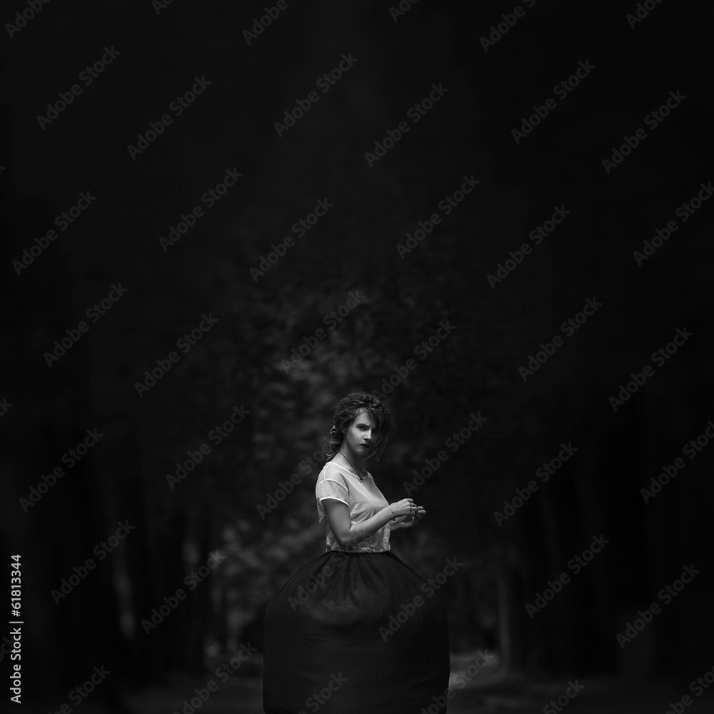 Art portrait of a lonely girl in the woods
